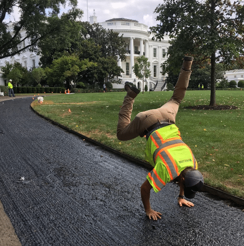 Kyle performing a hand stand on the driveway of the White House